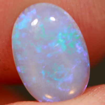 SOLID CRYSTAL OPAL Transparent with purple sparkles over a purple hue